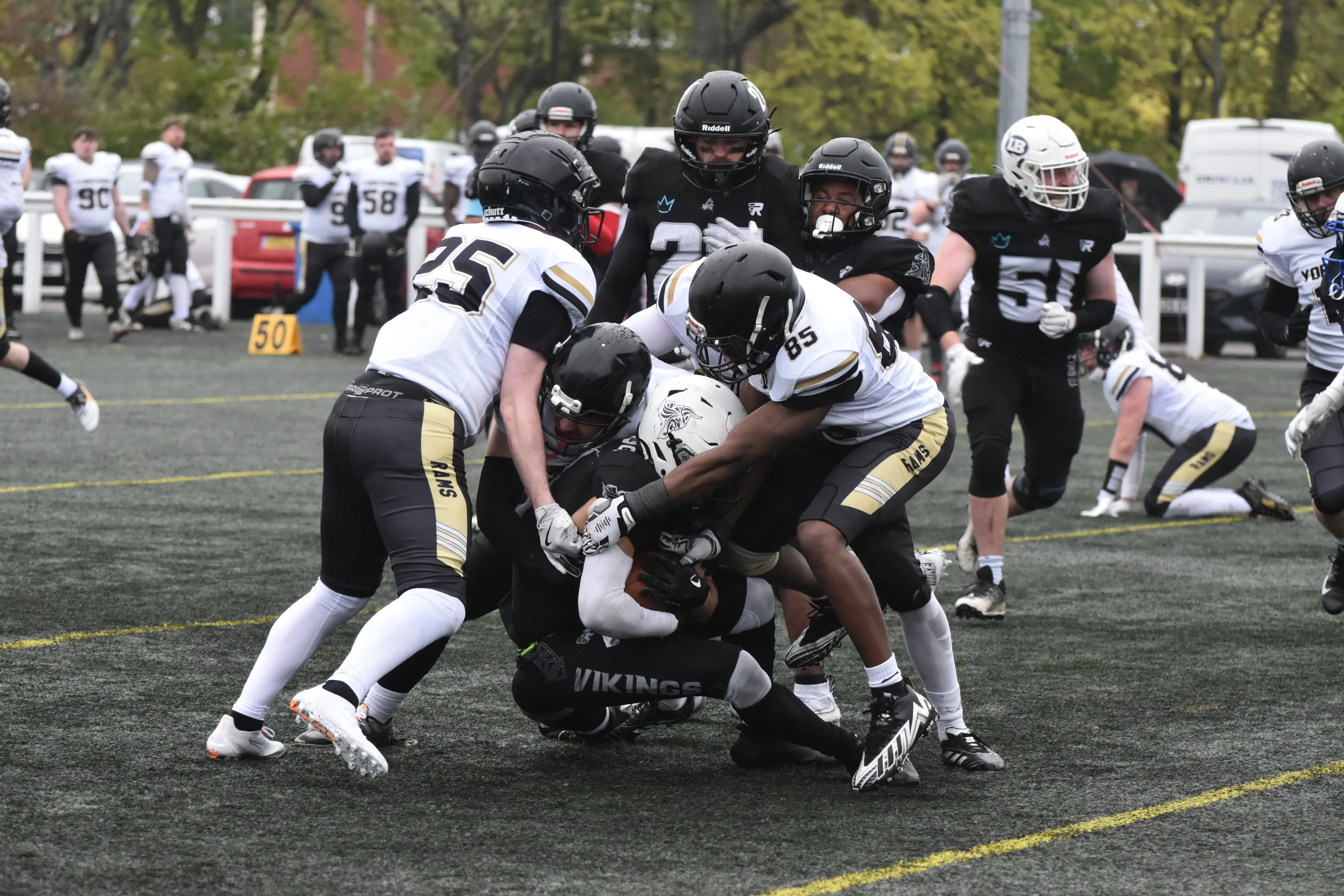The Rams defence swarms a Vikings ball carrier